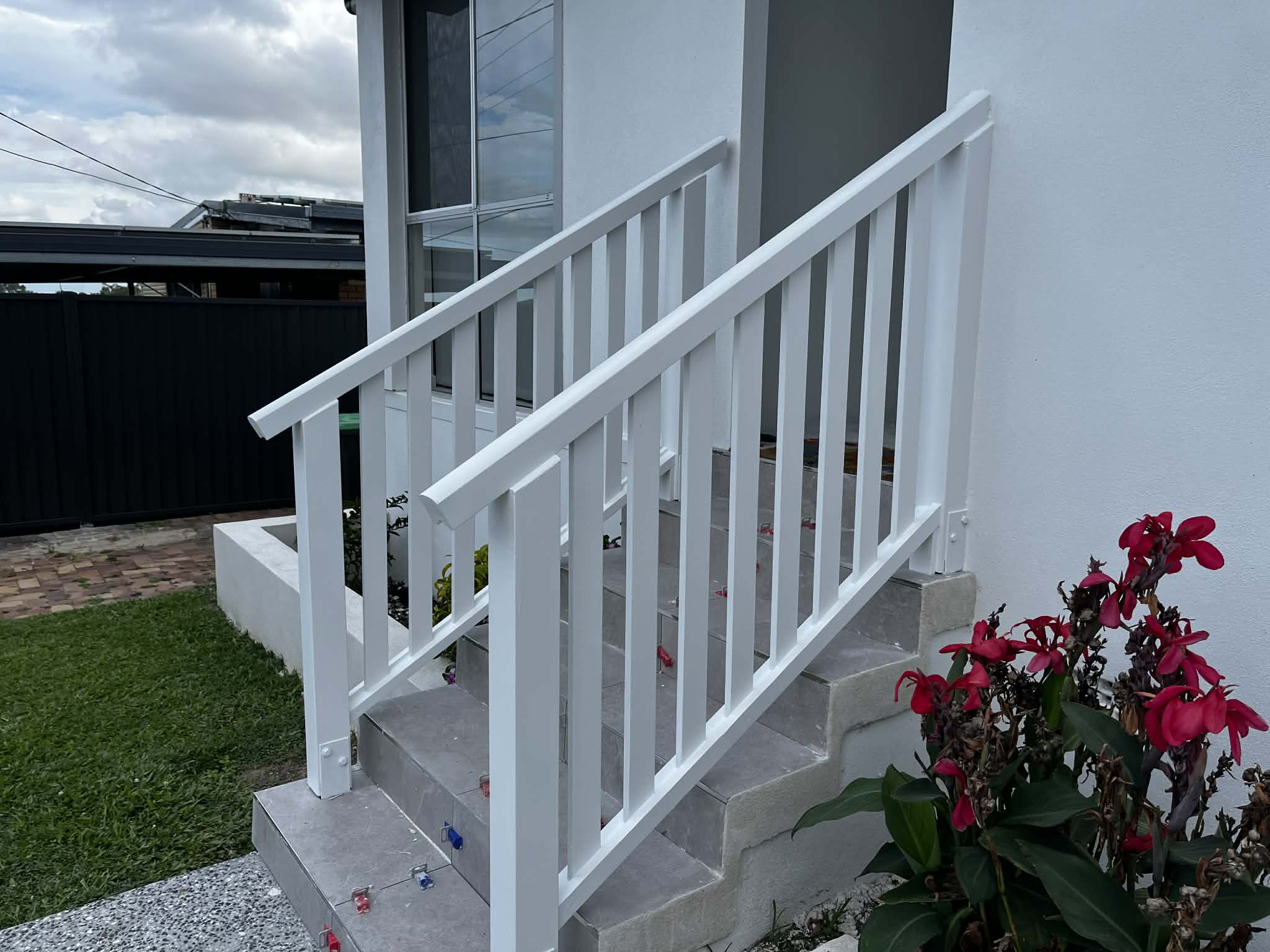 Freshly painted white exterior stair balustrades